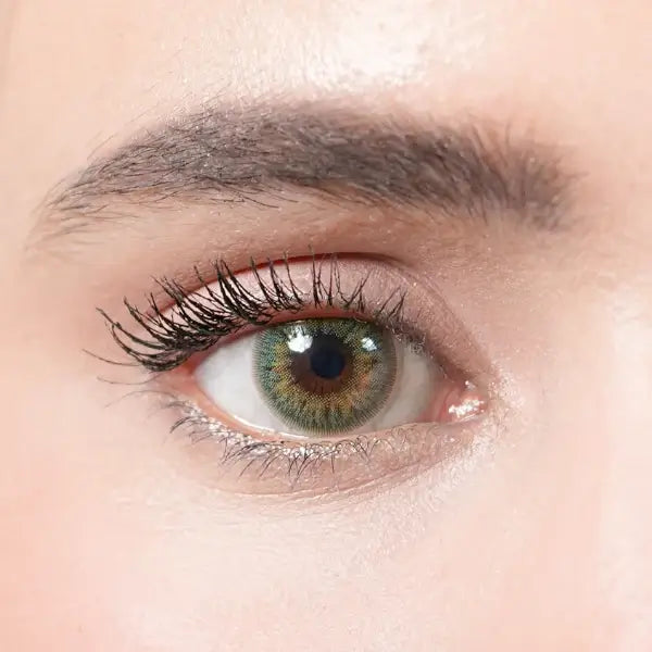 Close-up of a person's eye with detailed focus on the iris and eyelashes.
